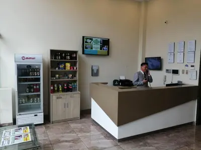a man talking on a phone at a counter in a store at Hotel Candamo in Lima