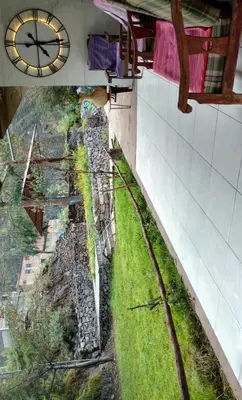 a clock on the side of a building with a train track at Alojamientos Támpur in San Mateo