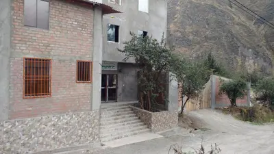 a brick building with stairs leading to a door at Alojamientos Támpur in San Mateo