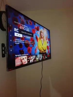 a flat screen tv hanging on a wall at Lopez House in Lima