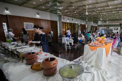 a group of people in a room with food on tables at Hotel Chavín in Barranca