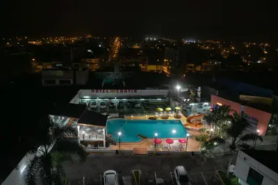 a view of a swimming pool at night at Hotel Chavín in Barranca