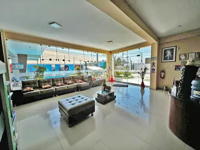 a large living room with couches and a large window at hotel el parral suite in Ica