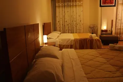 a hotel room with two beds in a room at hotel el parral suite in Ica