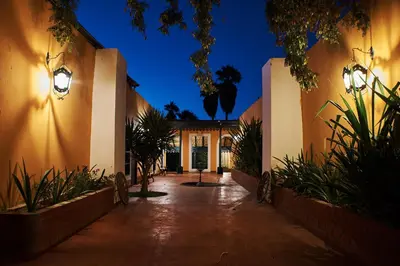 a courtyard of a house at night with lights at Hotel Majoro in Nazca