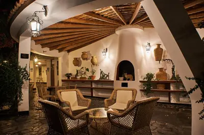 a room with chairs and a table in a building at Hotel Majoro in Nazca