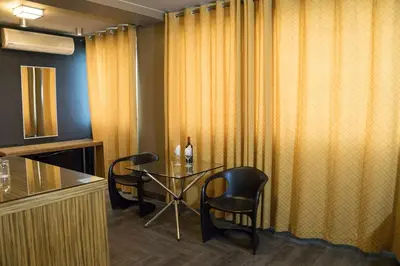 a dining room with a glass table and chairs at Hotel Las Lomas in Lima