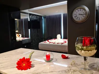 a room with a table with a wine glass and a clock at Hotel Las Lomas in Lima