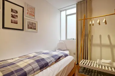 a bedroom with a bed and a window at InkaHuset Pacasmayo in Lima