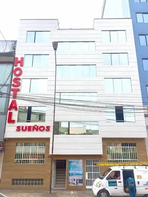 a white van parked in front of a building at Hostal Sueños in Lima
