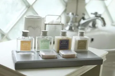 a bathroom counter with four bottles of soap and a sink at Quinta Miraflores Boutique Hotel in Lima