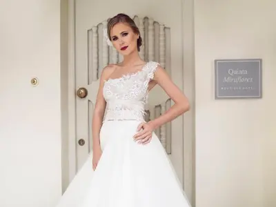 a model in a wedding dress standing next to a door at Quinta Miraflores Boutique Hotel in Lima