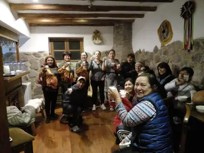 a group of people posing for a picture in a room at Picaflor Tambo Guest House in Ollantaytambo
