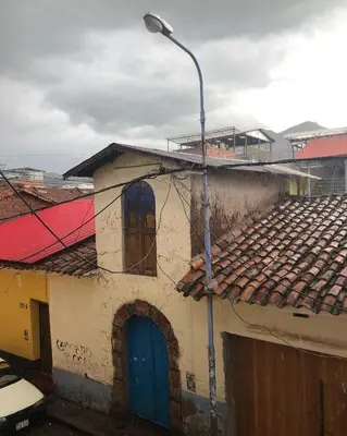a building with a street light next to it at Apartamento Cusco Queswa in Cusco