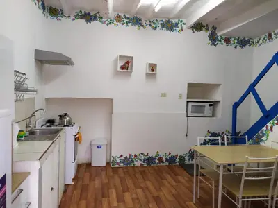 a kitchen with a sink and a table in a room at Apartamento Cusco Queswa in Cusco