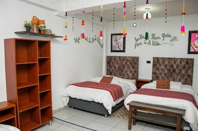 two beds in a room with lights on the wall at Magic Cusco in Cusco