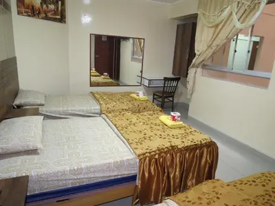 a bedroom with two beds and a mirror at HOTEL ESTRELLA in Lima