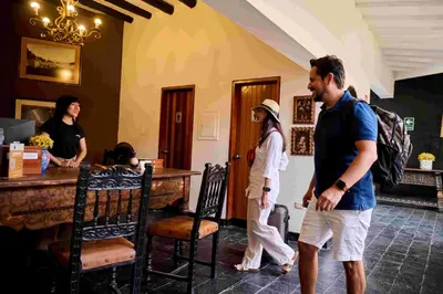 a man and a woman walking through a restaurant at Empedrada Ranch & Lodge - Hotel Asociado Casa Andina in Caral