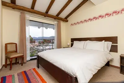 a bedroom with a large bed and a window at Luna House Cusco in Cusco