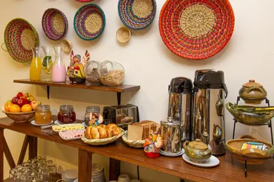 a table with a bunch of food and plates on a wall at Luna House Cusco in Cusco