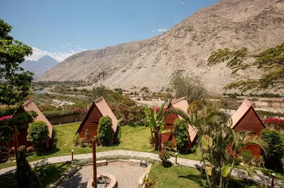 a view of a resort with a mountain in the background at La Confianza Hotel in Lunahuaná