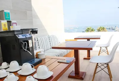 a living room with a table and a table and chairs at Casa Paracas in Paracas