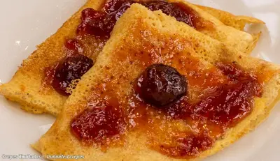 two pieces of toast with jam on a white plate at El Mariscal Cusco in Cusco