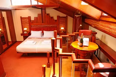 a bedroom with a bed and a table and chairs at Hotel Waynapicchu in Cusco