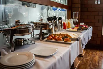 a buffet line with food on a table at Hotel Waynapicchu in Cusco