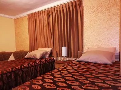 a hotel room with two beds and a window at Hatun Quilla in Cusco