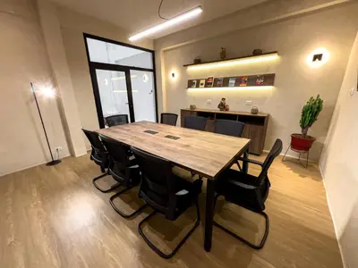 a conference room with a wooden table and chairs at La Mansion Casa Hotel in Andahuaylas