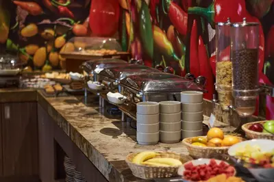 a buffet with fruits and other food on a counter at Xima Lima San Isidro in Lima