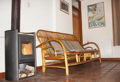 a wooden bench sitting next to a wood stove at Maison Fortaleza in Cusco