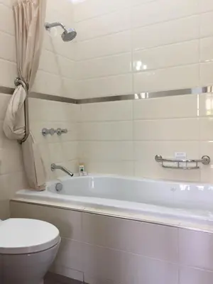 a bathroom with a white tub and a toilet at Zen Home & Garden House in Cieneguilla