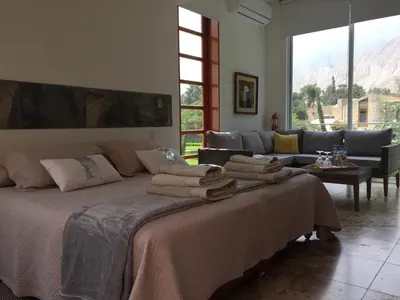 a bedroom with a bed with towels on it at Zen Home & Garden House in Cieneguilla