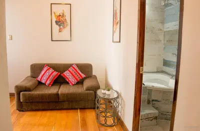 a living room with a couch and a sink at Auka Boutique San Blas in Cusco