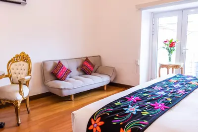 a living room with a couch and a bed at Auka Boutique San Blas in Cusco