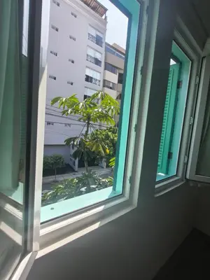 an open window with a view of a tree at La Casona Azul in Lima