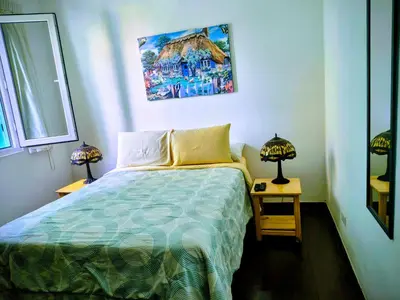 a bedroom with a bed and two tables with lamps at La Casona Azul in Lima