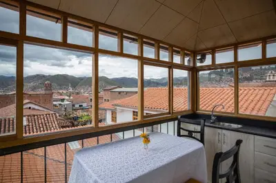 a kitchen with a table and views of a city at MOAF Cusco Boutique Hotel in Cusco