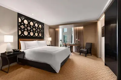 a bedroom with a large white bed and a table at Hilton Lima Miraflores in Lima