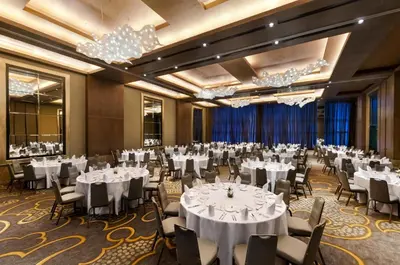 a banquet hall with white tables and chairs and chandeliers at Hilton Lima Miraflores in Lima