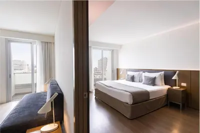 a hotel room with a bed and a balcony at Dazzler by Wyndham Lima San Isidro in Lima