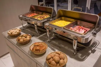 a buffet filled with different types of food and baskets at Dazzler by Wyndham Lima San Isidro in Lima