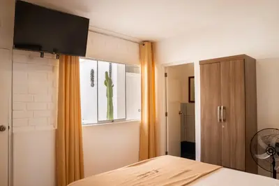 a bedroom with a bed and a window at Hostal Los Frayles in Paracas