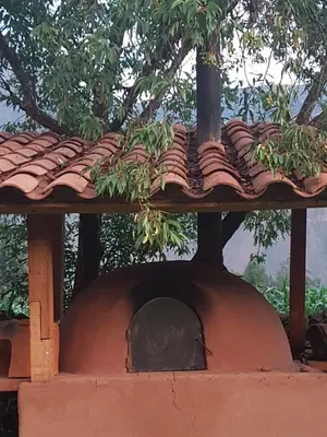 a brick oven with a roof on top of it at Mágico lugar en el Valle Sagrado in Cusco