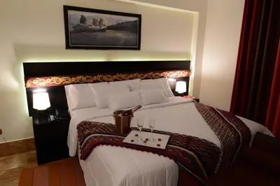 a hotel room with a bed with a tray on it at Altipacha Ayacucho Hotel in Ayacucho