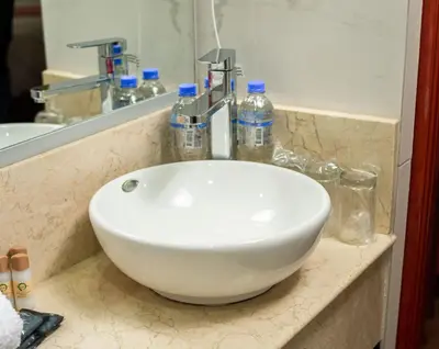 a white sink sitting on a counter in a bathroom at Altipacha Ayacucho Hotel in Ayacucho