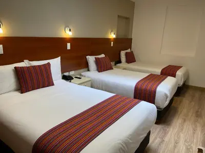 a hotel room with two beds in a room at Hotel San Pedro Plaza in Cusco