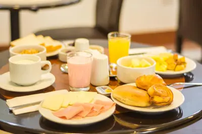 a table topped with plates of food and drinks at Hotel San Pedro Plaza in Cusco